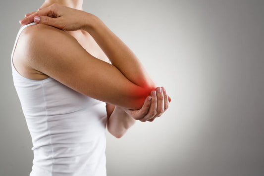 A woman clutching her elbow which is highlighted red to denote pain
